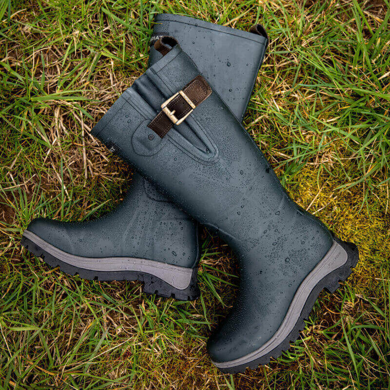 Ariat Woodstock Rubber Boot Deep Navy with buckles on grass.