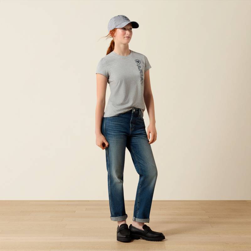 Person in Ariat Youth Vertical Logo SS T-Shirt Heather Grey/Navy, gray cap, jeans, black shoes.