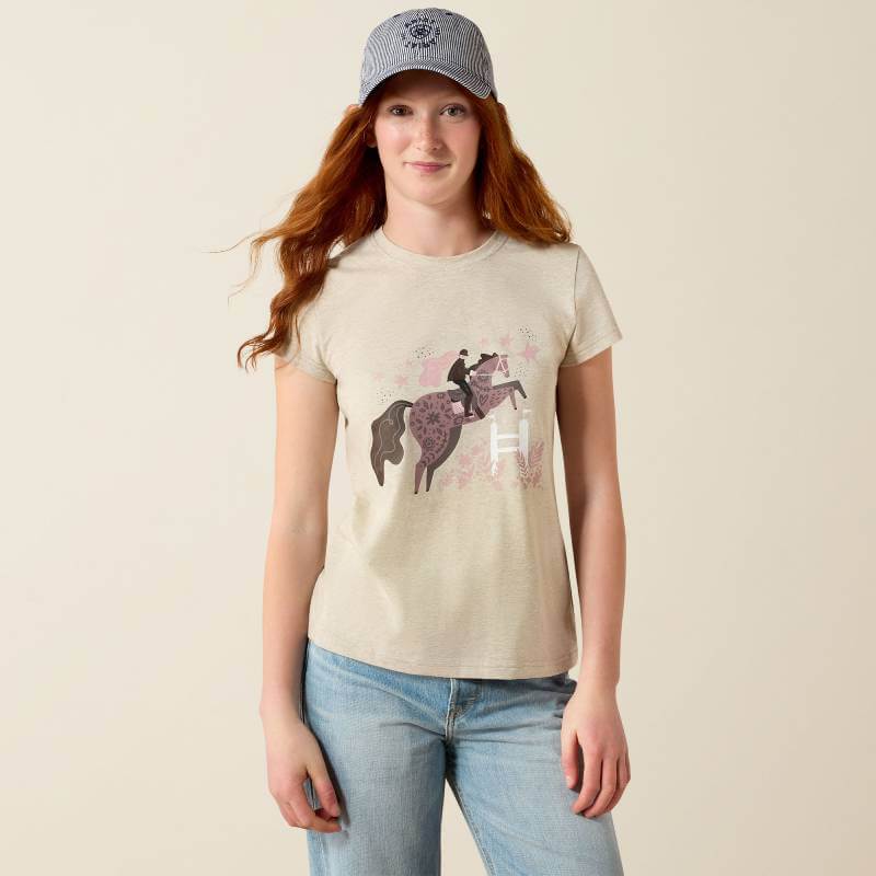 Woman in cap and jeans wearing Ariat Youth Floral Leap SS T-Shirt Oatmeal.