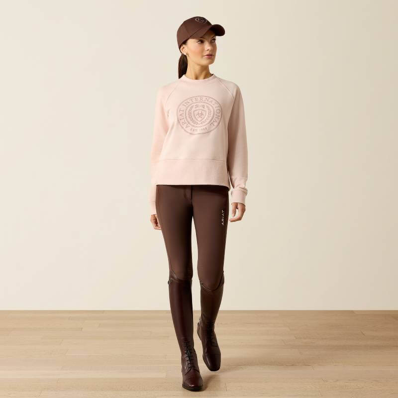 Woman indoors in Ariat Womens Martine Sweatshirt Sepia Rose, organic cotton fleece.