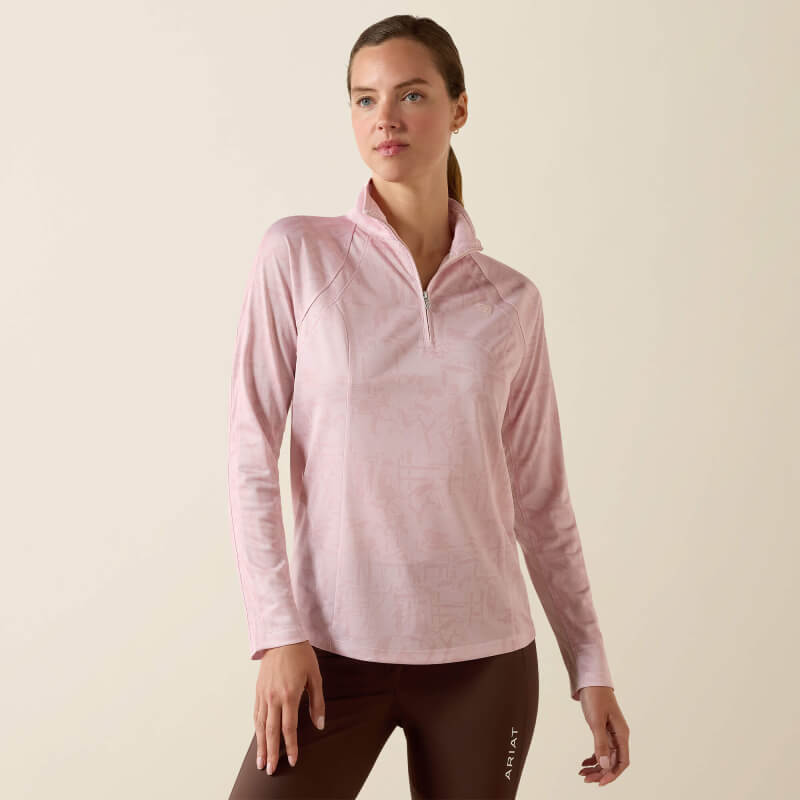 Woman wears Ariat Womens Sunstopper 3.0 Baselayer Sepia Rose Horse Park and brown leggings.