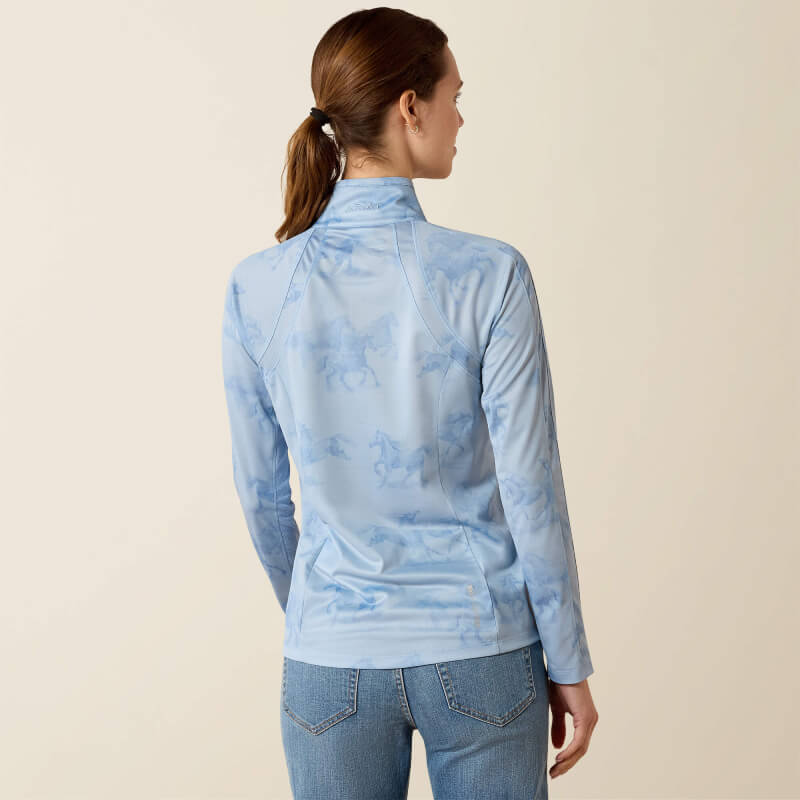 Woman in Ariat Sunstopper 3.0 Baselayer St. Tropez Mirage print, facing away in jeans.