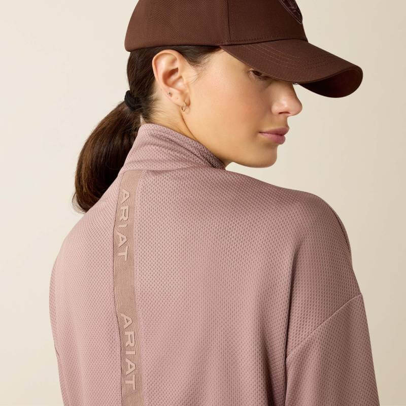 Woman in a brown cap and Ariat Womens Breathe 1/2 Zip Pullover Antler, facing away.