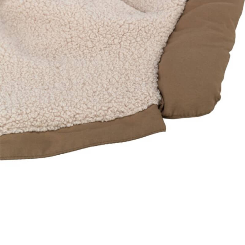 Close-up of a beige fleece pet bed, perfect with the Trixie Pirou Coat with Harness Sand.