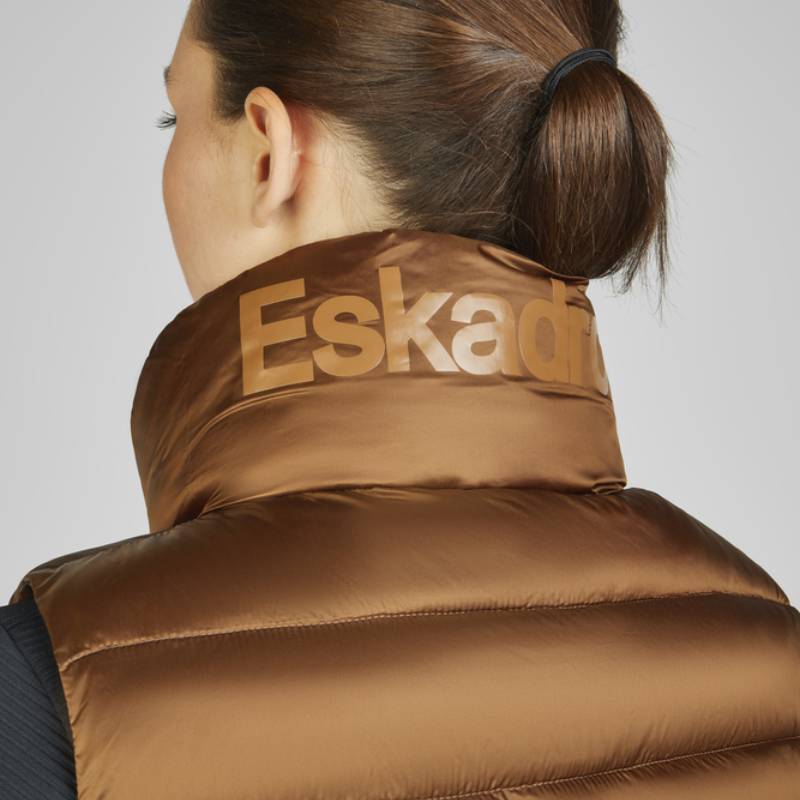 Woman with brown hair in a bun wears the Eskadron Heritage Quilt Waistcoat in Almond.