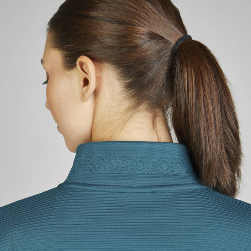 Woman with brown hair in a ponytail wears Eskadron Heritage Zip-Shirt Vintage Green.