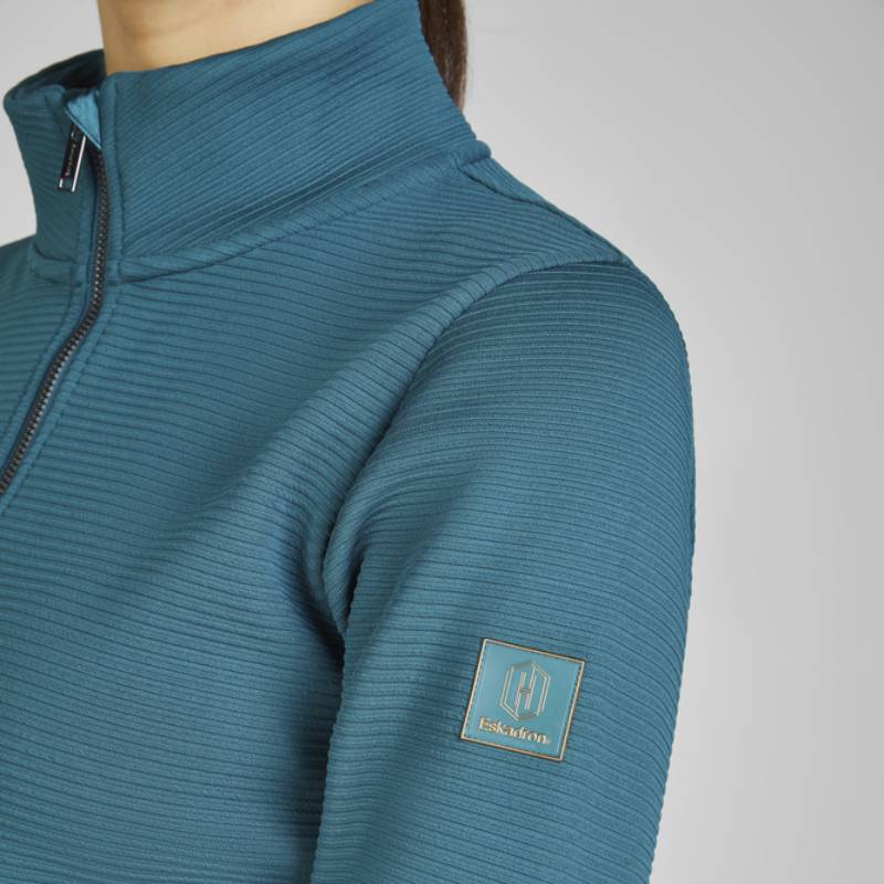 Person wearing the Eskadron Heritage Zip-Shirt Vintage Green with logo patch on upper sleeve.