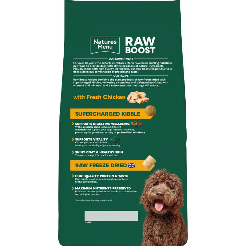 Green bag of Natures Menu Raw Boost Complete Dog Food Chicken with a brown fluffy dog bottom right.