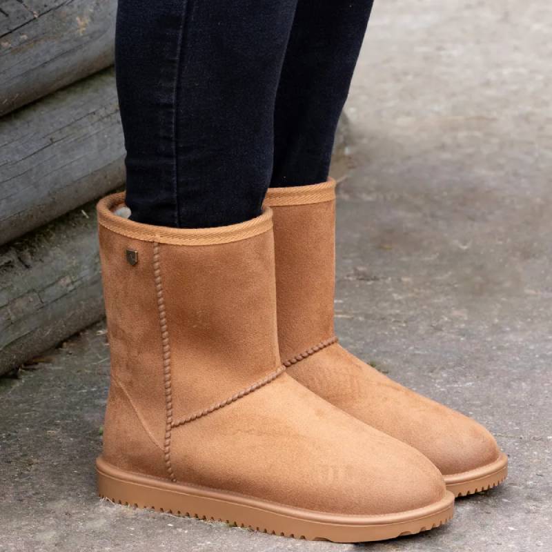 Child wearing Hy Equestrian Hy Chisworth Waterproof Fleece Boot Childs Camel on concrete.