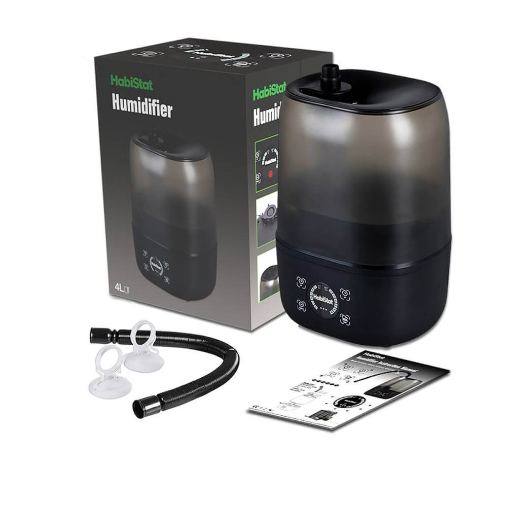 Habistat HabiStat Humidifier releases mist in a glass terrarium with plants.