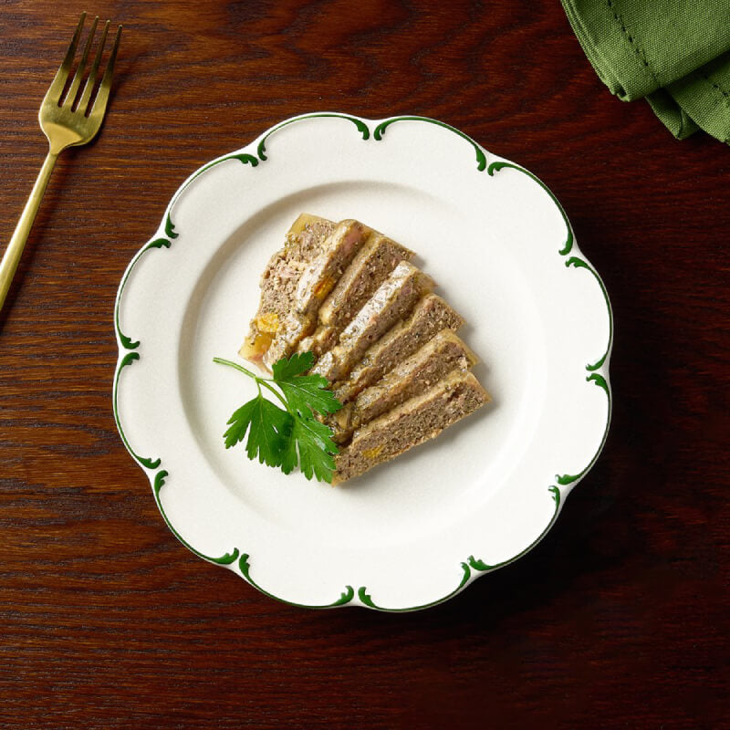 Canagan Petite Chicken & Wild Boar Pate for Dogs 100g served on a plate beside a gold fork.
