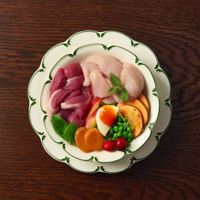 Canagan Petite Chicken & Duck Dog Dry Food features meats, veggies, peas, egg, and herbs.