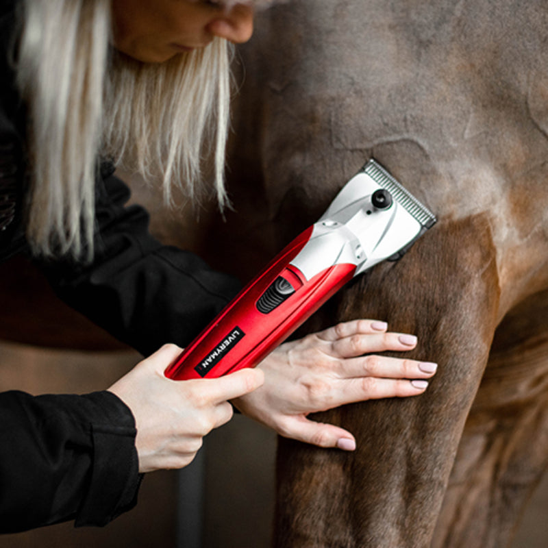A person trims an animal’s leg with a Liveryman Black Beauty mains powered clipper.
