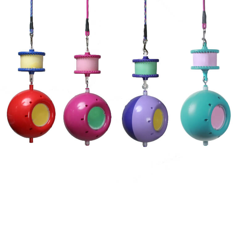 Four colorful hanging cat toys with spool tops, like the Likit Boredom Breaker by Likit.
