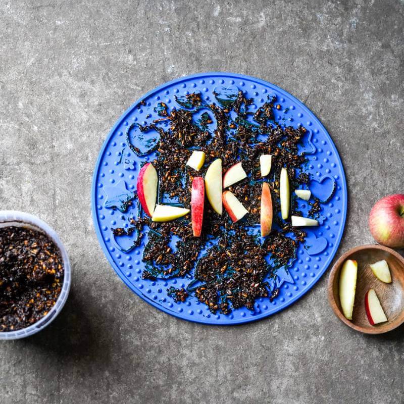 Likit Graze Maze Blue with "LIKE" spelled in apple slices, surrounded by dark chopped food.