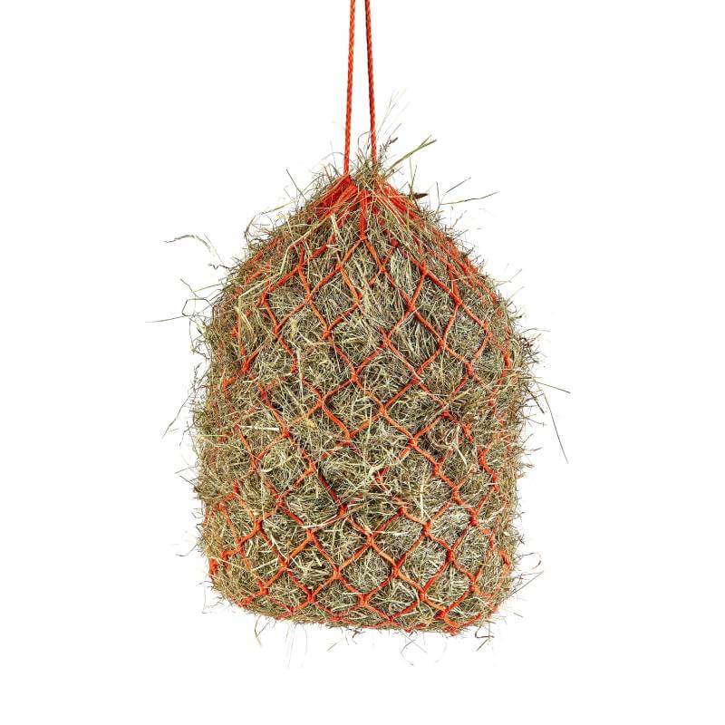 A Shires Haylage Net filled with hay hangs by a rope.