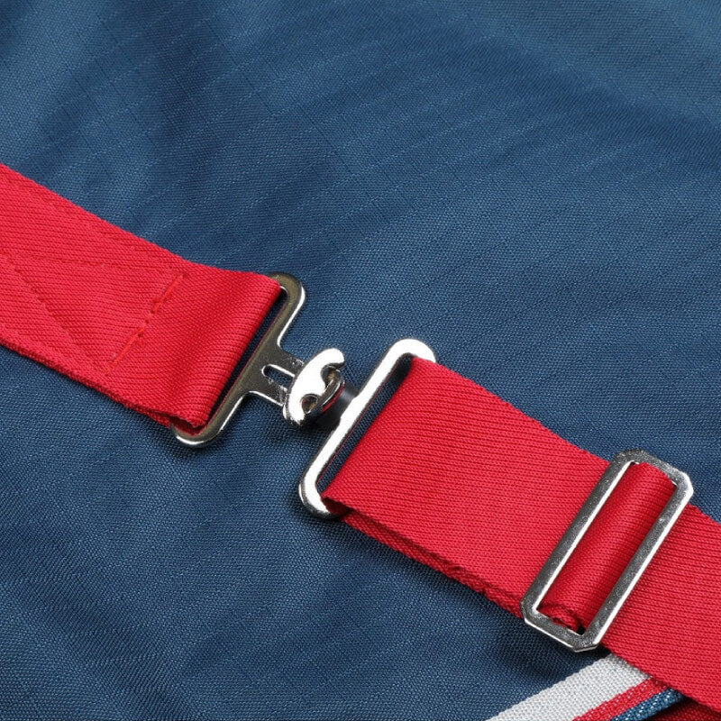 Red strap buckle fastened on the Shires Tempest Original Lite Turnout Rug Teal.