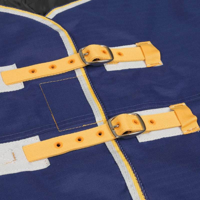 Close-up of Tempest navy turnout rug with yellow straps and metal buckles.