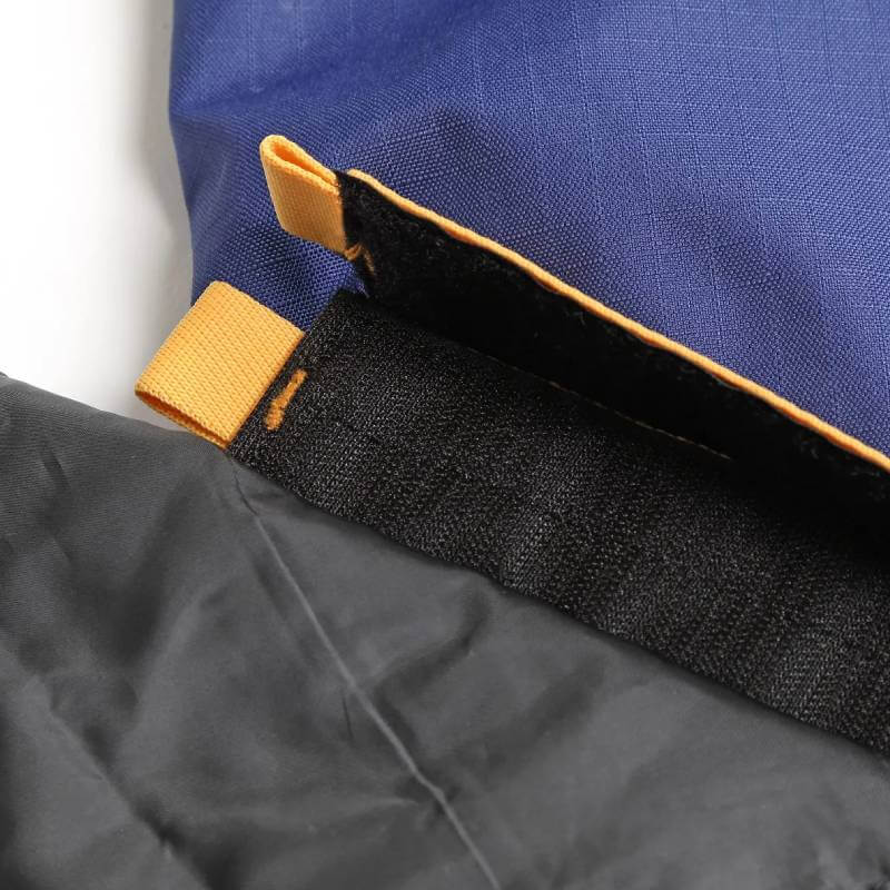 Close-up of navy waterproof Tempest turnout rug with Velcro, orange pull tabs, and neck set.