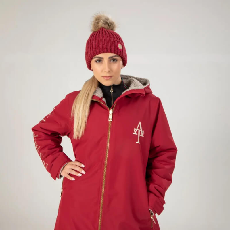 Aubrion Team Winter Hat Red: Red beanie with faux fur pom pom and round metal emblem by Aubrion.
