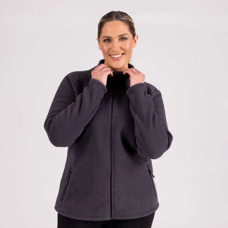 Smiling woman wears Aubrion Restore Full Zip Fleece Charcoal against light background.