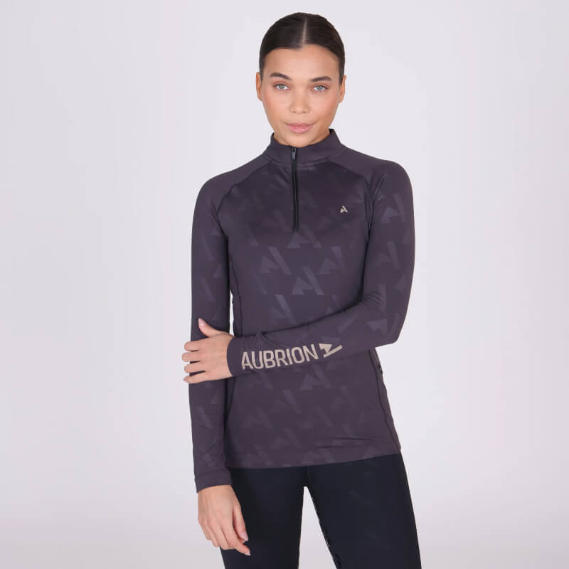 Woman in Aubrion React Winter Baselayer Shadow, ideal for winter riding.