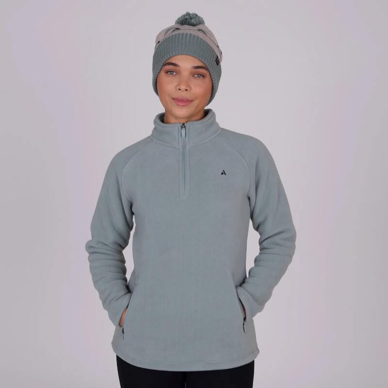 Person wears the Aubrion React Half Zip Fleece Sage with hands in pockets, facing forward.