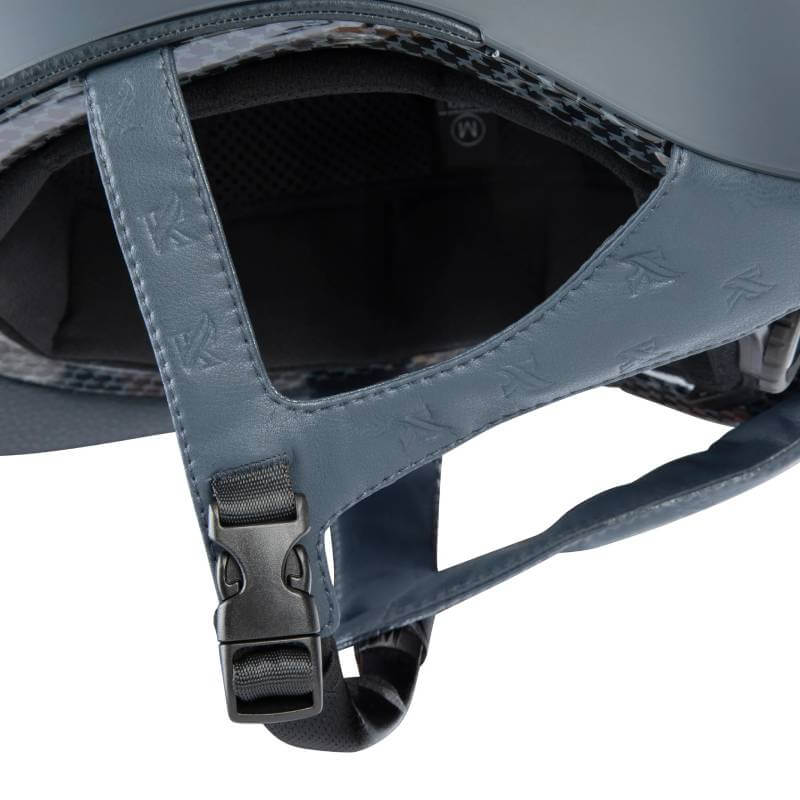 Close-up of Shires Karben Amity LTHR Riding Hat Navy strap with black buckle.