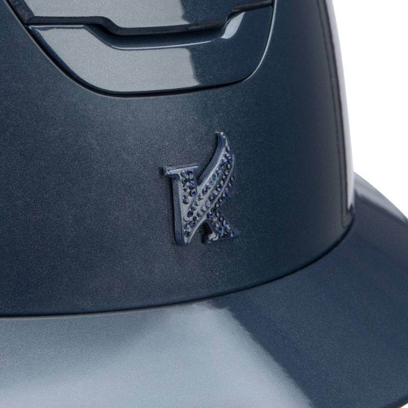 Close-up of the Shires Karben Amity SPKL Riding Hat Navy with a raised winged K logo.