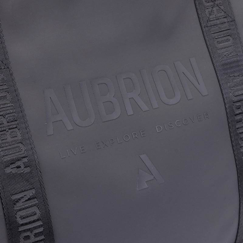 Close-up of a black Aubrion React Tote Bag with embossed text: Live Explore Discover.