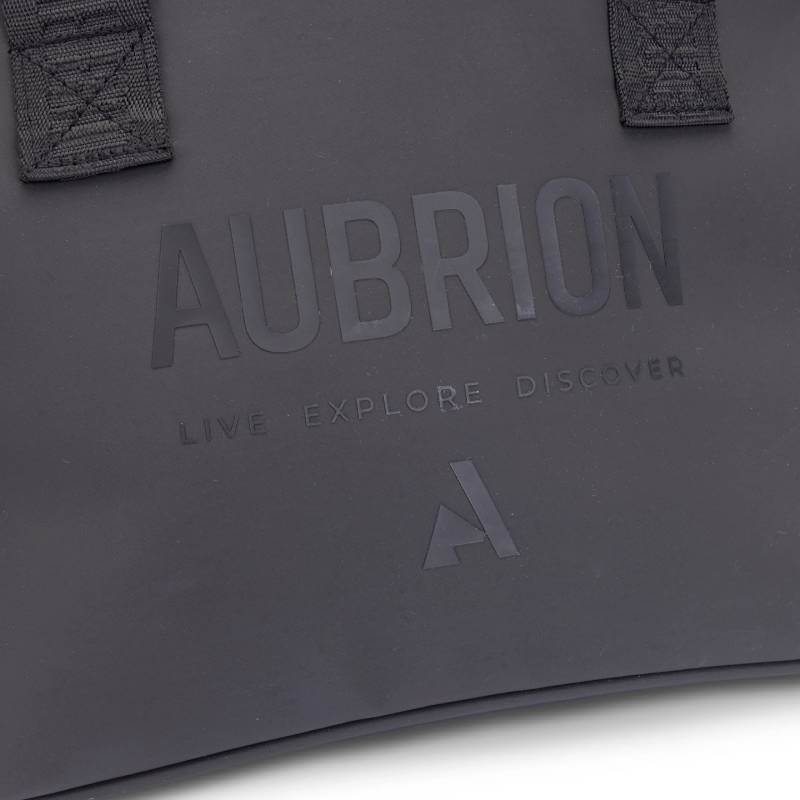 Aubrion React Hat Bag Black with wide branded straps and zipper, angled on white.
