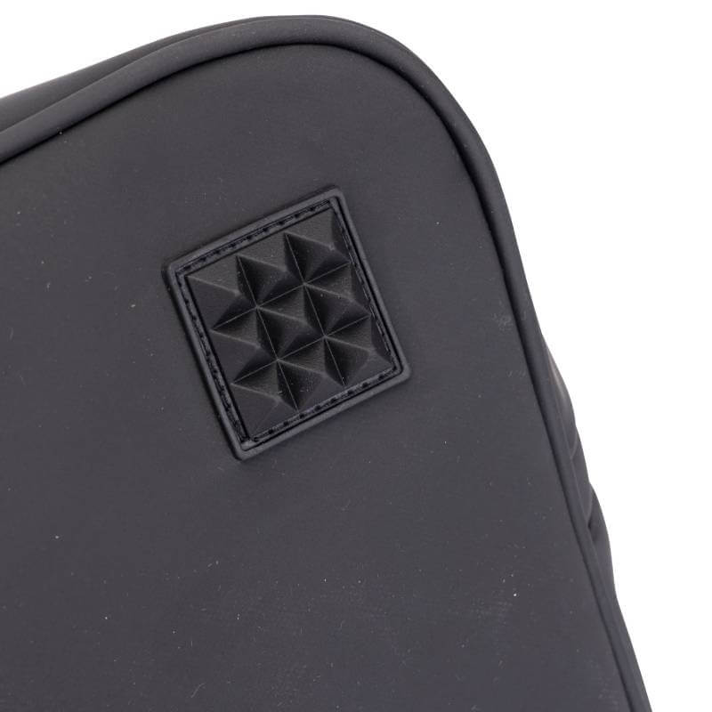 Close-up of an Aubrion React Hat Bag Black with a square, pyramid-studded patch detail.