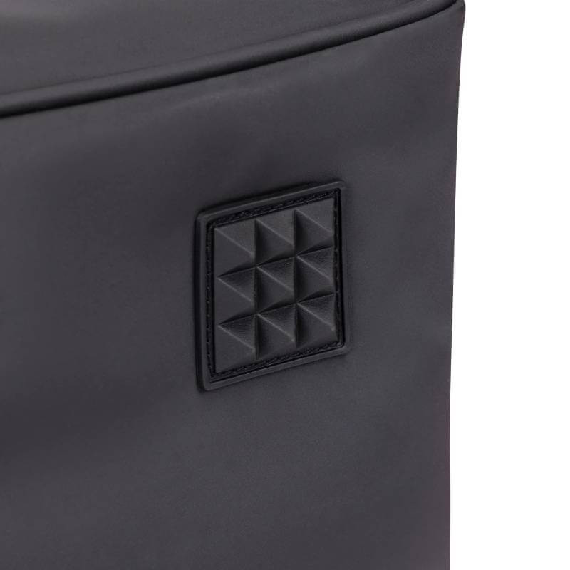 Close-up of Aubrion React Long Boot Bag Black’s textured patch on smooth, padded fabric.