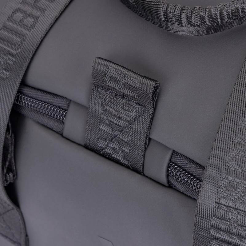 Close-up of black zipper and strap on Aubrion React Grooming Kit Bag Black with textured details.