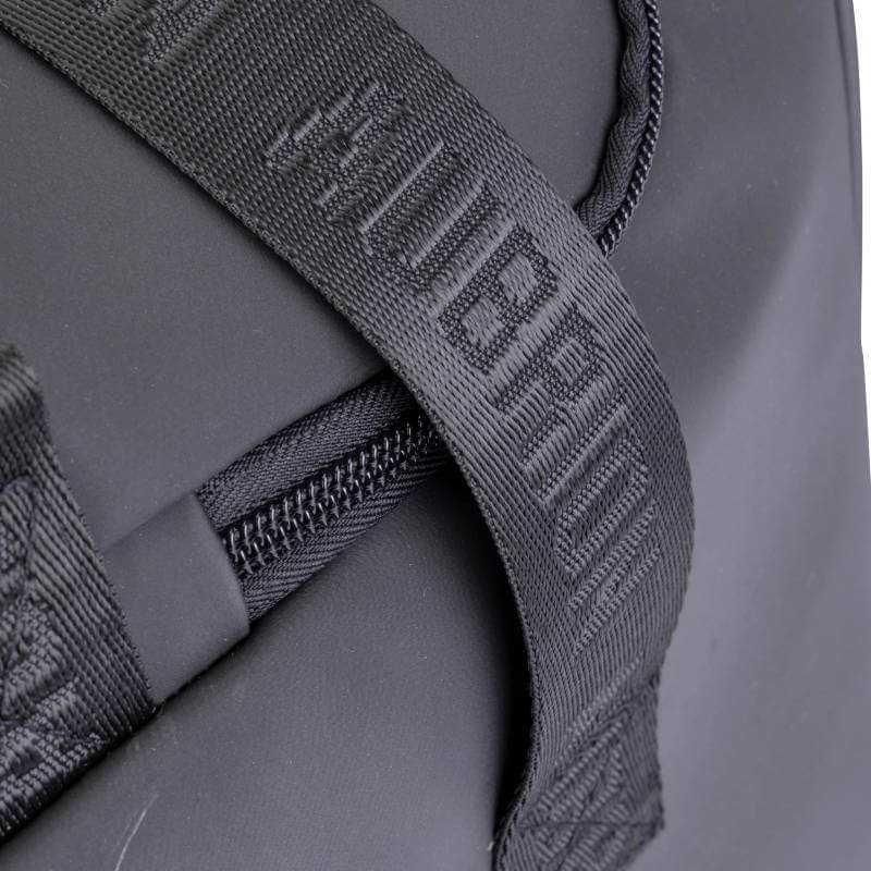 Close-up of the Aubrion React Grooming Kit Bag Black with a textured strap and raised branding.
