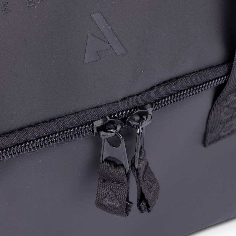 Close-up of two black zipper pulls on the Aubrion React Grooming Kit Bag Black.