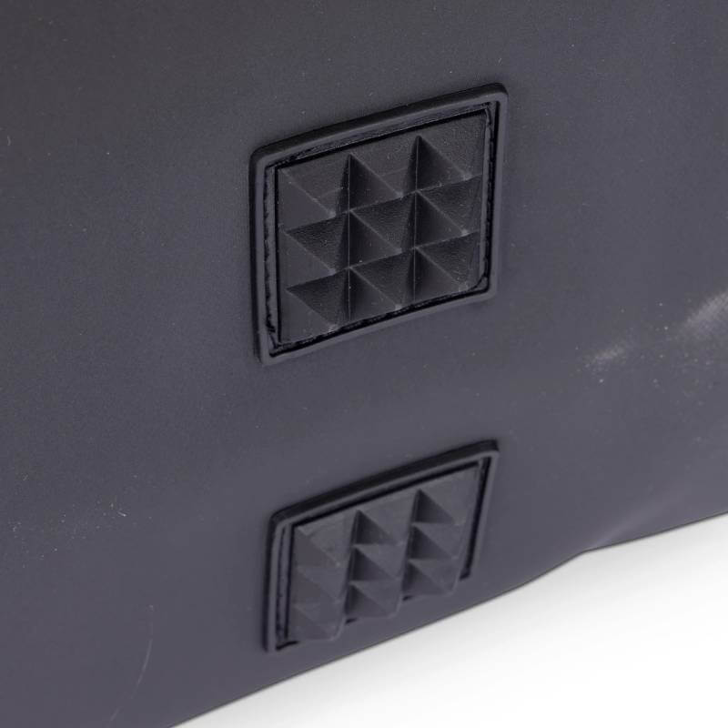 Close-up of two black, pyramid-studded rubber patches on the Aubrion React Grooming Kit Bag.