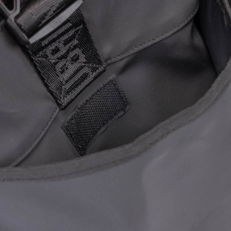 Interior of the Aubrion React Large Grooming Kit Bag Black showing fabric tag and black strap.