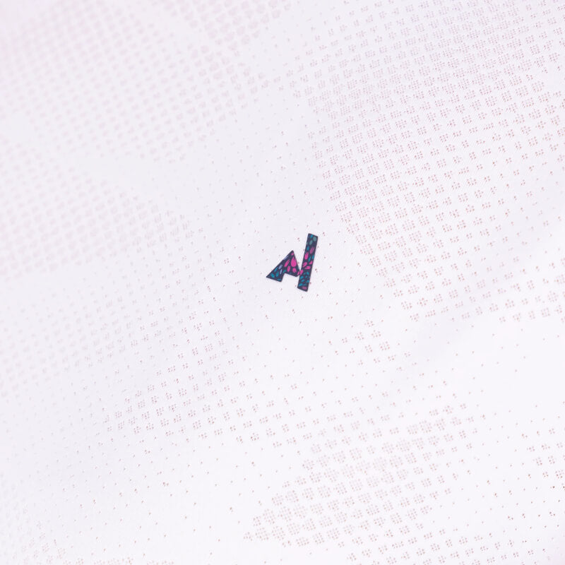 Woman wears Aubrion React Tech T-Shirt White and navy leggings against a plain, light background.