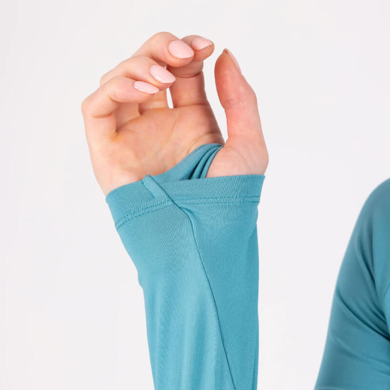 Hand in an Aubrion React Long Sleeve Baselayer Haze with thumb through the thumbhole.