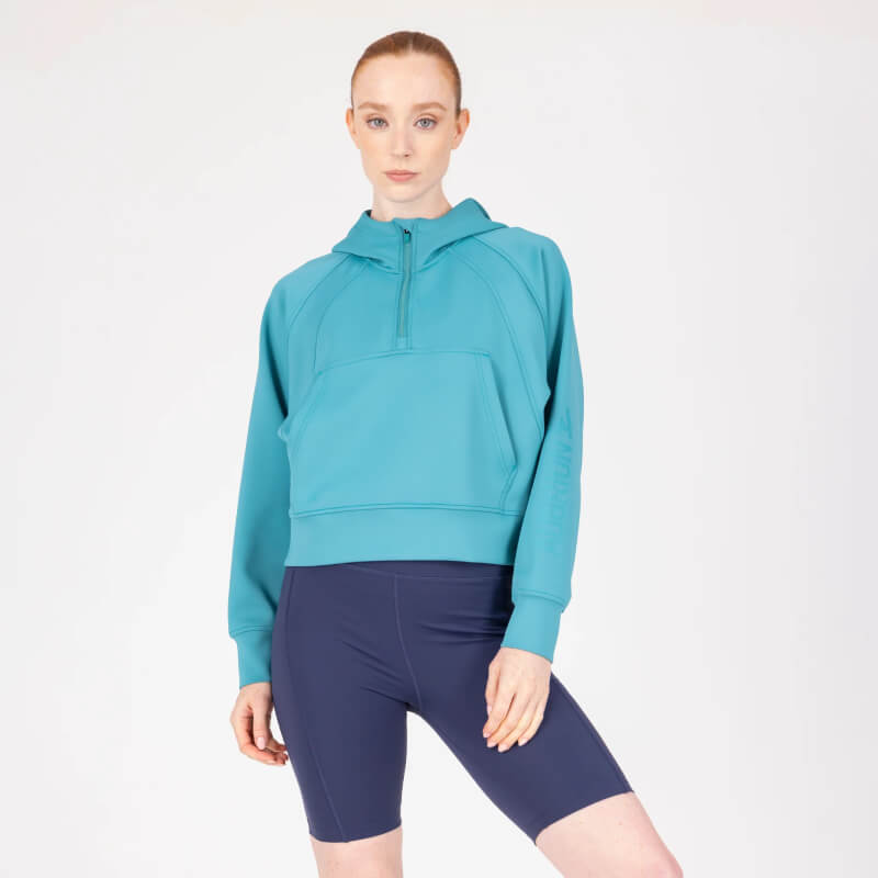 Person wears the Aubrion React Quarter Zip Hoodie Haze, standing before a plain white background.
