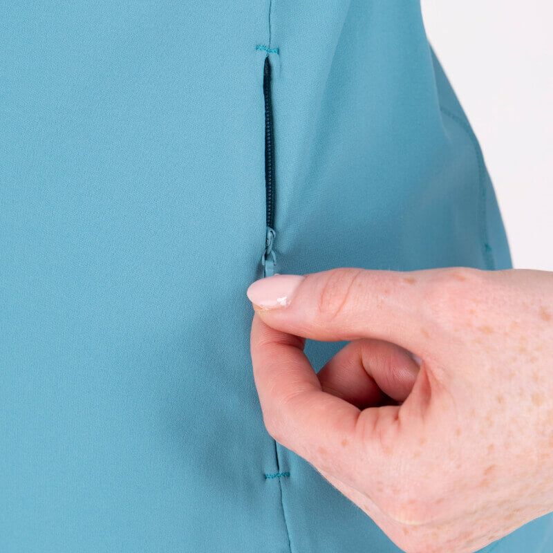 Hand opening hidden zipper pocket on Aubrion React Mid Layer Haze for comfort and moisture control.
