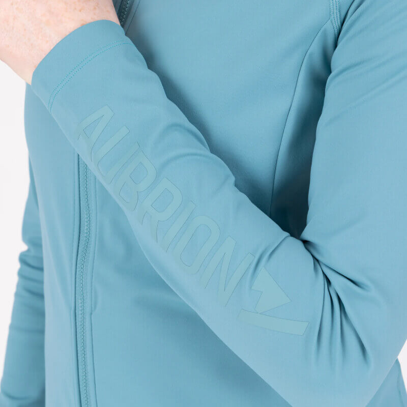 Person in an Aubrion React Mid Layer Haze jacket with sleeve text.