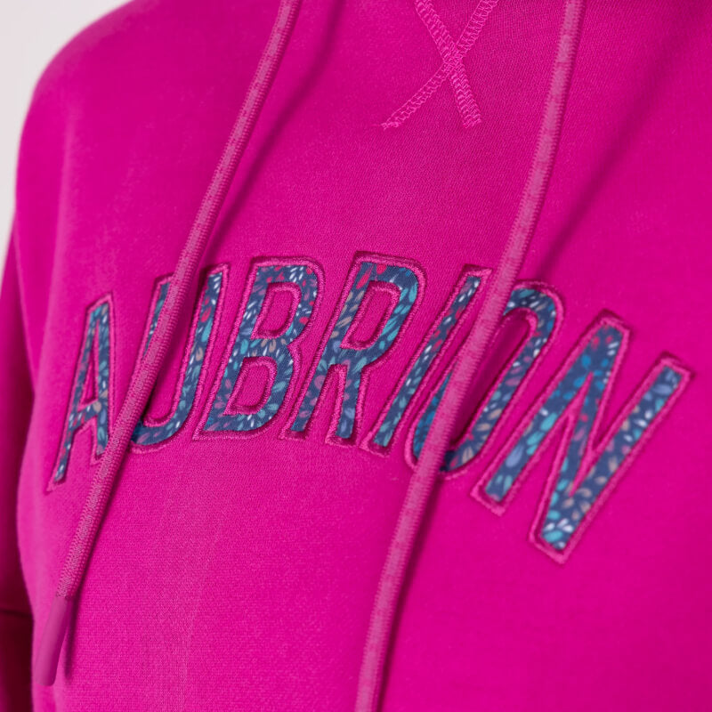 Aubrion React Hoodie Fuchsia: cozy pink French terry with blue logo, ideal for post-ride comfort.