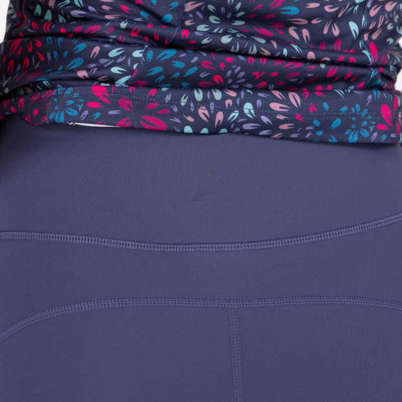 Person in dark purple leggings, floral top, and Aubrion React Non-Stop Shorts Midnight, back view.