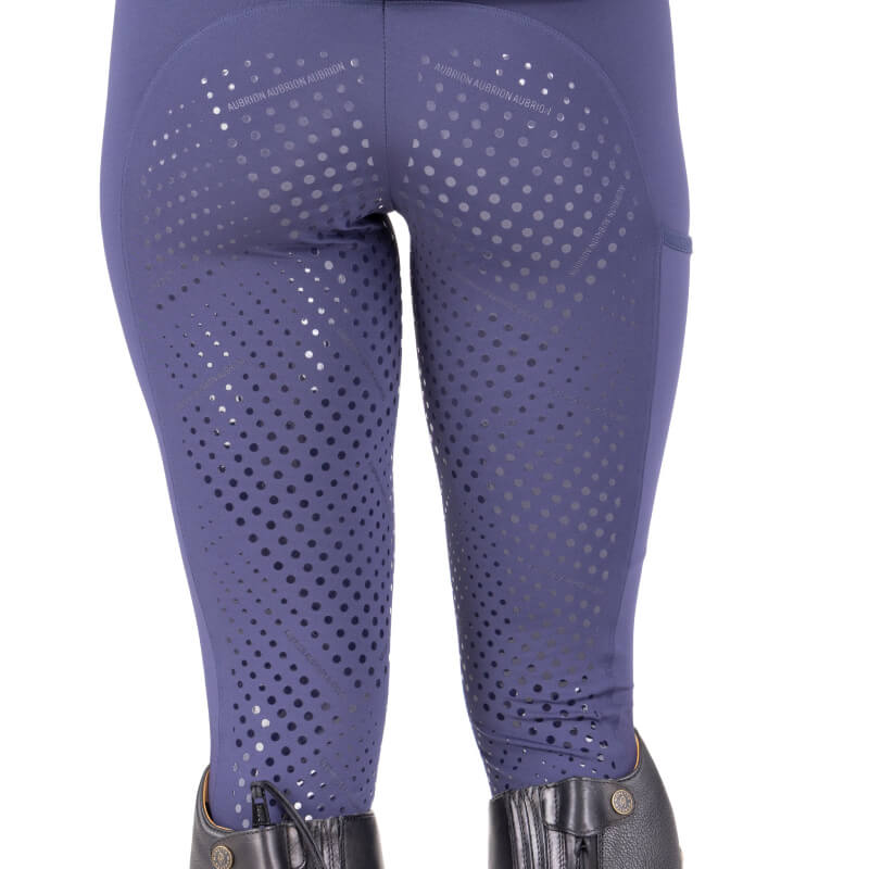 Close-up: Aubrion React Sculpt Riding Tights Midnight with dotted grip and black riding boots.