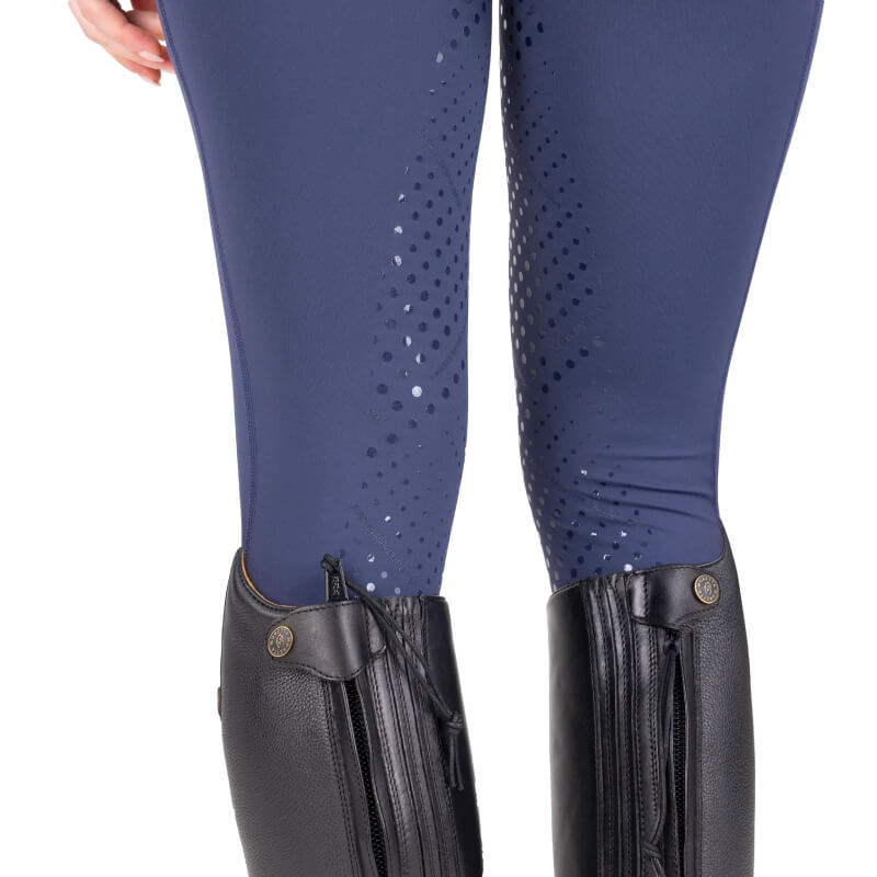 Close-up of person in Aubrion React Non-Stop Riding Tights Midnight and black knee-high boots.