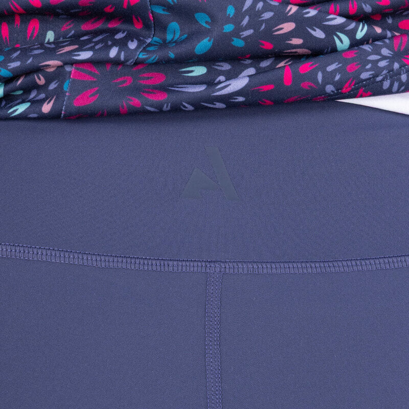 Aubrion React Non-Stop Riding Tights Midnight shown with visible seams and a floral top.