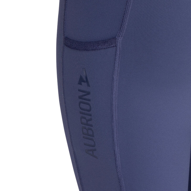 Close-up of Aubrion React Non-Stop Riding Tights Young Rider with 4-way stretch, side pocket.