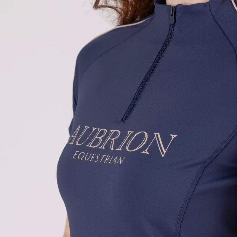 Close-up of a person in a navy Aubrion Equestrian Short Sleeve Baselayer Midnight with zipper.